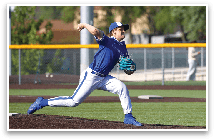 A baseball player in a blue and white uniform is throwing a ball. Description generated by AI