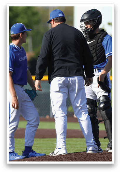 A baseball player wearing a blue shirt and blue hat. Description generated by AI