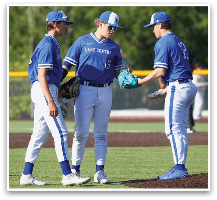 Three baseball players wearing blue uniforms. Description generated by AI