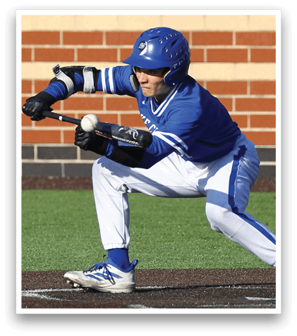 A baseball player in a blue and white uniform is bending over to catch a ball. Description generated by AI