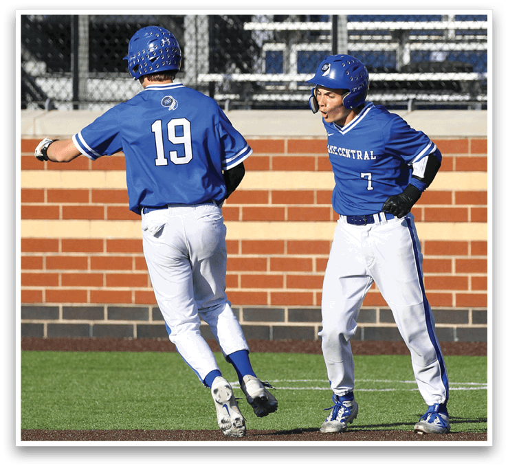 Two baseball players wearing blue and white uniforms. Description generated by AI