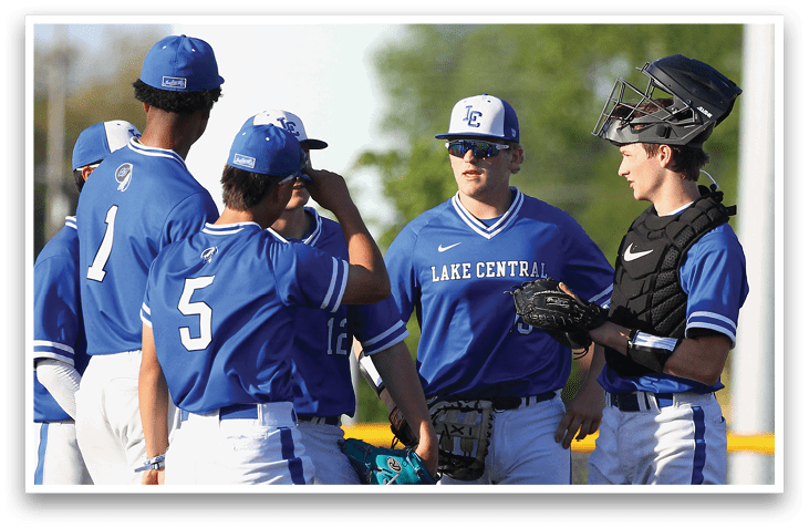 A group of baseball players wearing blue uniforms. Description generated by AI