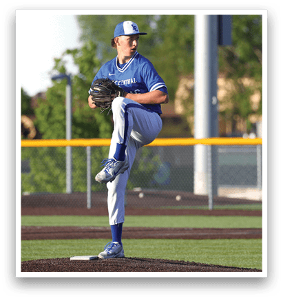 A baseball player in a blue and white uniform is pitching a ball. Description generated by AI
