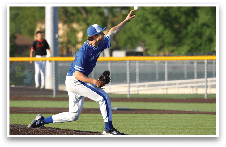 A baseball player in a blue shirt and white pants is throwing a ball. Description generated by AI