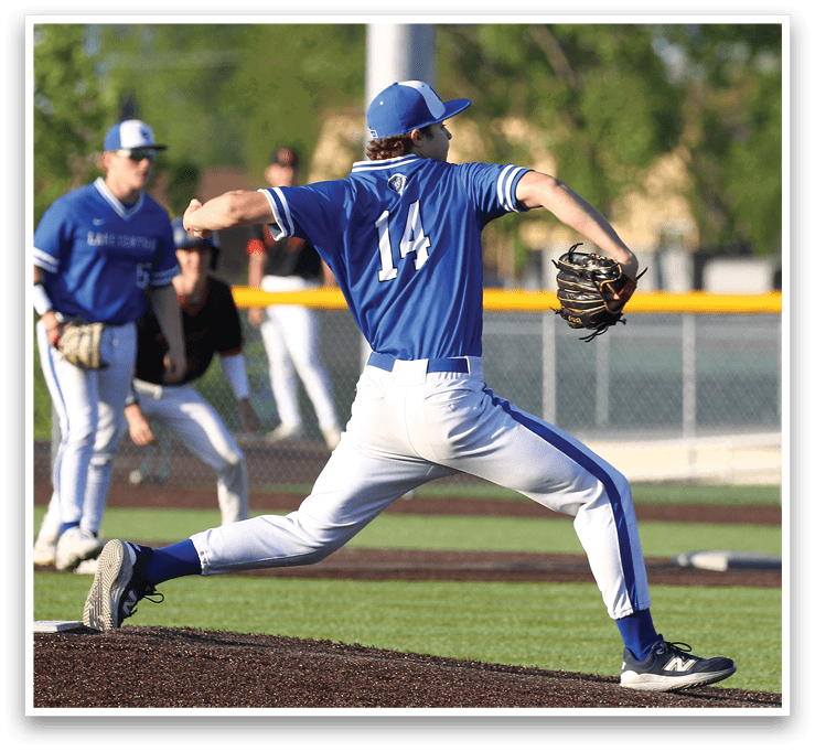 A baseball player wearing a blue shirt and number 14 is throwing a ball. Description generated by AI
