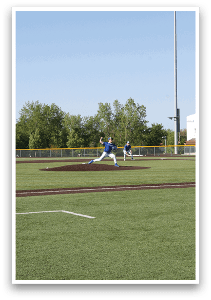A baseball player is throwing a ball on a field. Description generated by AI
