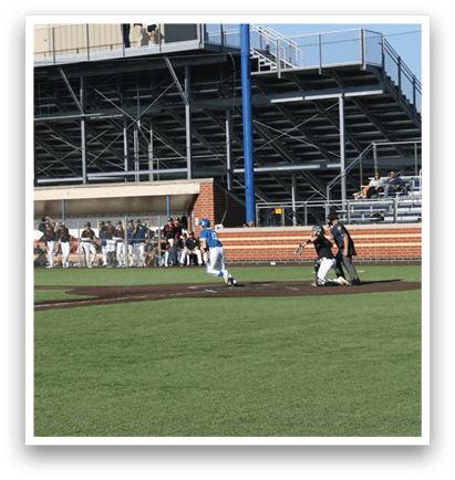 A baseball game is taking place on a field with a crowd of people watching. Description generated by AI