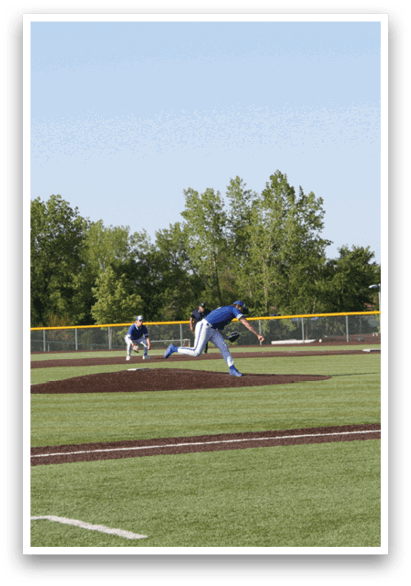 A baseball player in a blue shirt and white pants is throwing a ball. Description generated by AI