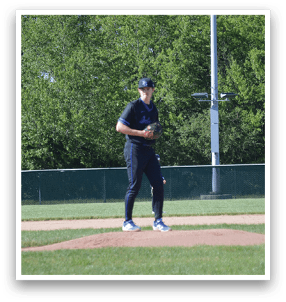 A baseball player standing on a mound. Description generated by AI