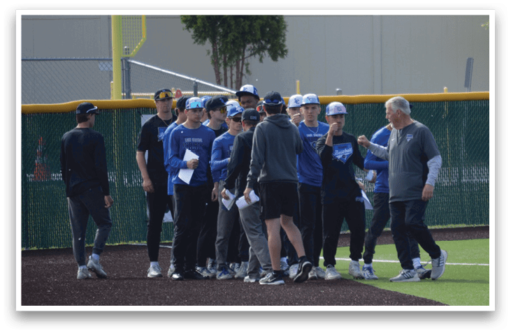 A group of baseball players wearing blue and grey uniforms. Description generated by AI
