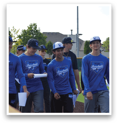 A group of baseball players wearing blue shirts and black pants. Description generated by AI