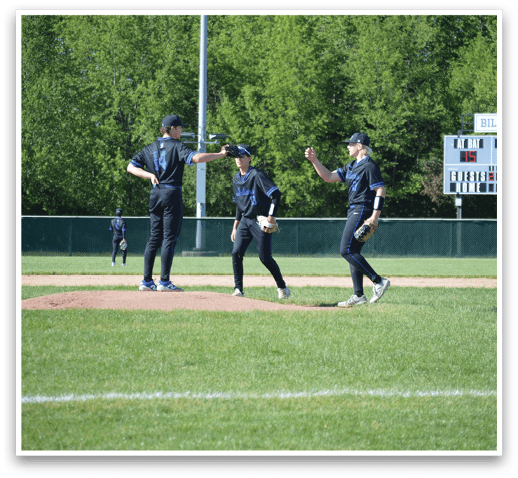 Three men in black and blue uniforms standing on a baseball field. Description generated by AI
