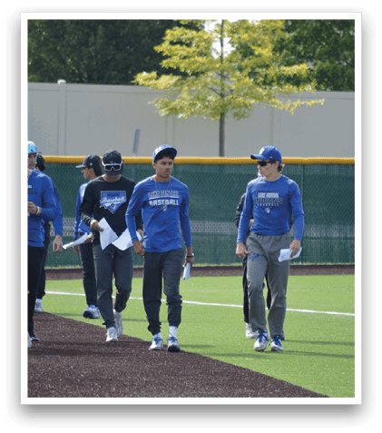 A group of baseball players walking on a field. Description generated by AI