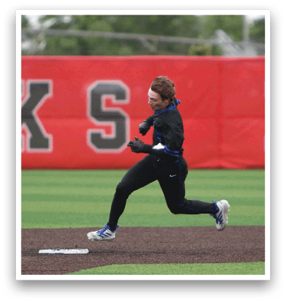A person running on a baseball field. Description generated by AI