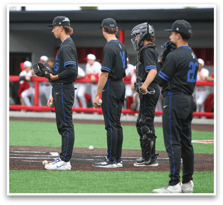 A group of baseball players standing on the field. Description generated by AI