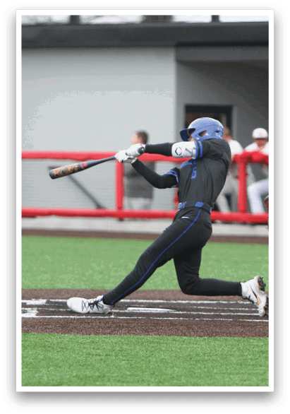 A baseball player in a blue shirt and black pants is swinging a bat. Description generated by AI