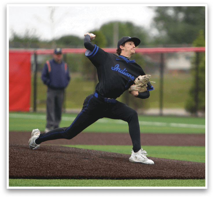 A baseball player in a black shirt and blue cap is pitching a ball. Description generated by AI