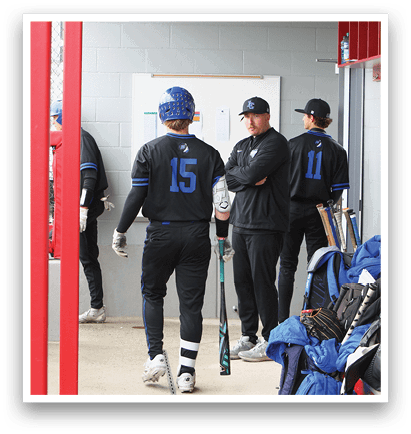 A group of baseball players standing in a dugout. Description generated by AI