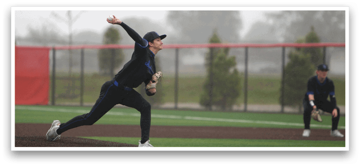 A baseball player in a black shirt and hat is pitching a ball. Description generated by AI