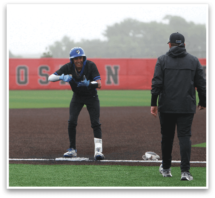 A baseball player is standing on home plate with a bat. Description generated by AI