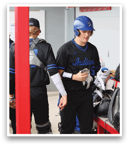 A group of baseball players in a dugout. Description generated by AI