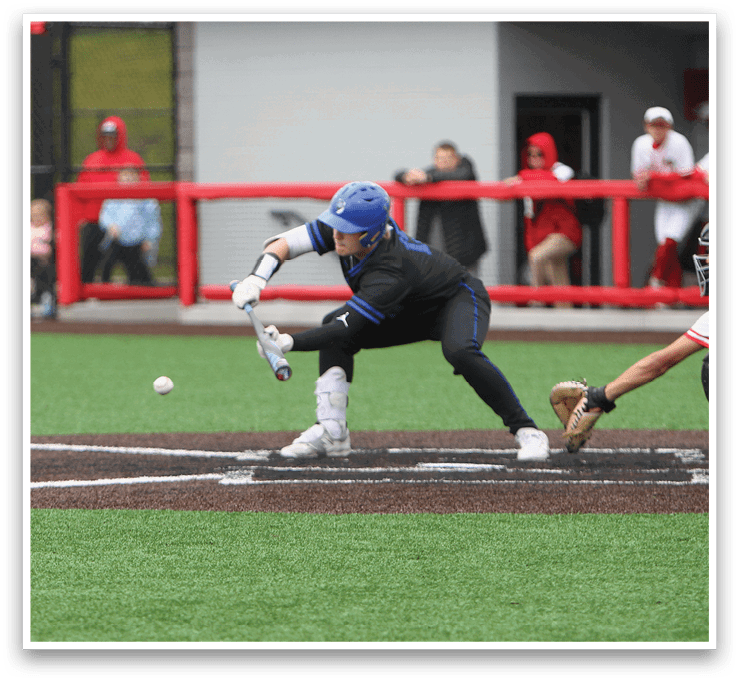 A baseball player in a blue helmet and black uniform is catching a ball. Description generated by AI