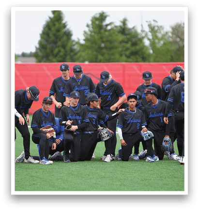 A group of baseball players wearing blue and black uniforms. Description generated by AI