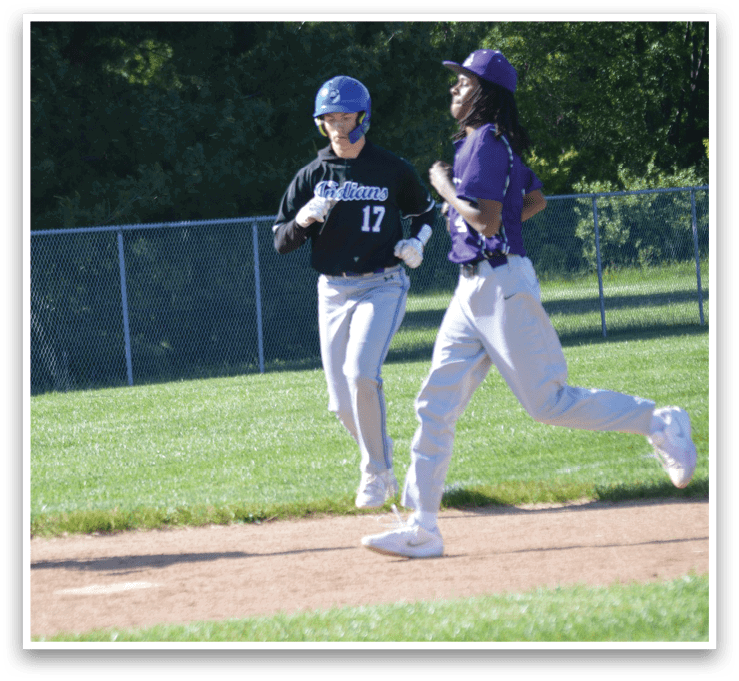 A baseball game is taking place with a player running to the base. Description generated by AI