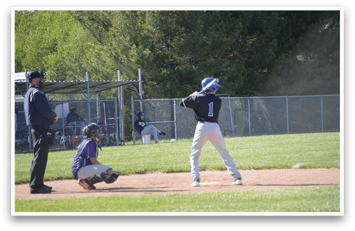 A baseball player is at bat, wearing a blue helmet. Description generated by AI