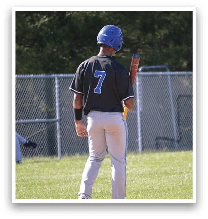 A baseball player wearing a blue helmet and a black shirt with the number 7 on it. Description generated by AI