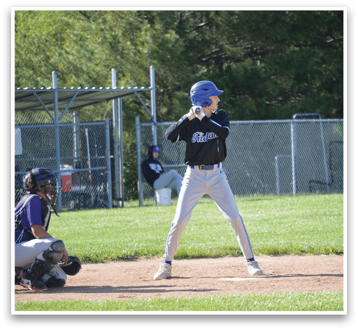 A baseball player in a blue helmet and black shirt is holding a bat and getting ready to hit a ball. Description generated by AI