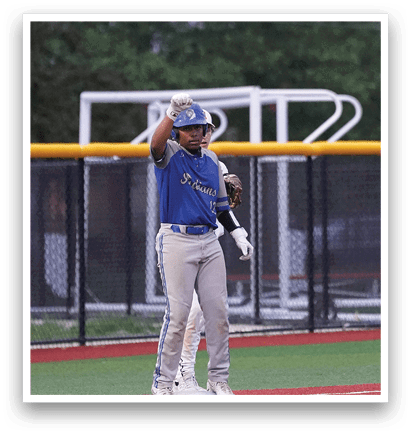 A baseball player wearing a blue shirt and white pants is standing on a field. Description generated by AI