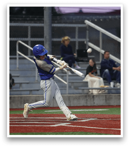 A baseball player in a blue and white uniform is swinging a bat at a ball. Description generated by AI