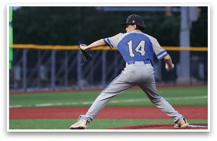 A baseball player in a blue and white uniform is pitching a ball. Description generated by AI