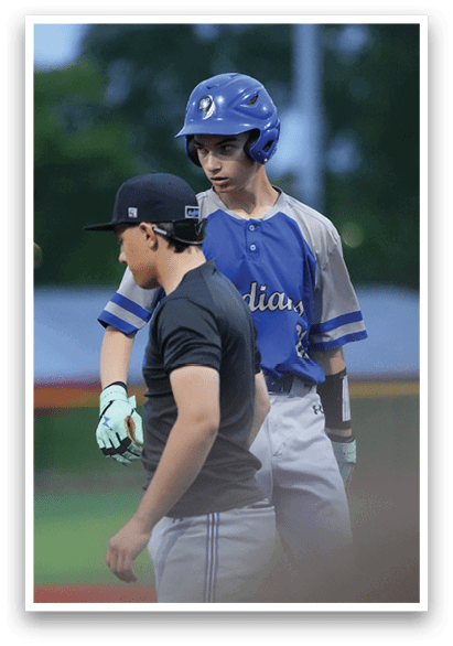 A boy wearing a blue and white shirt and a blue helmet. Description generated by AI