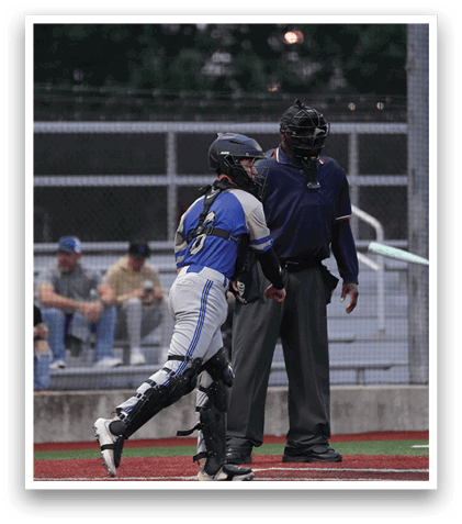 A boy in a blue and white uniform is running to first base. Description generated by AI