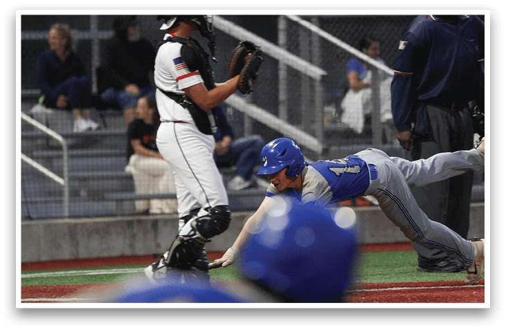 A baseball player sliding into home plate. Description generated by AI