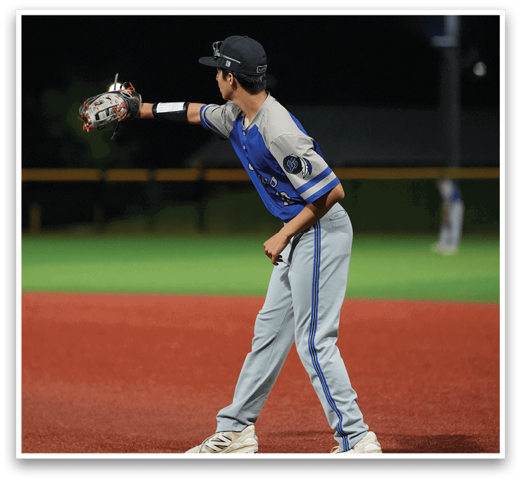 A baseball player wearing a blue and grey uniform is throwing a ball. Description generated by AI