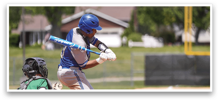 A baseball player is swinging a bat at a ball. Description generated by AI