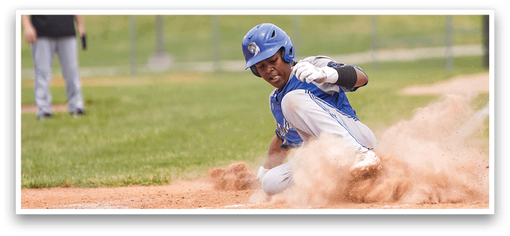 A baseball player slides into home plate. Description generated by AI