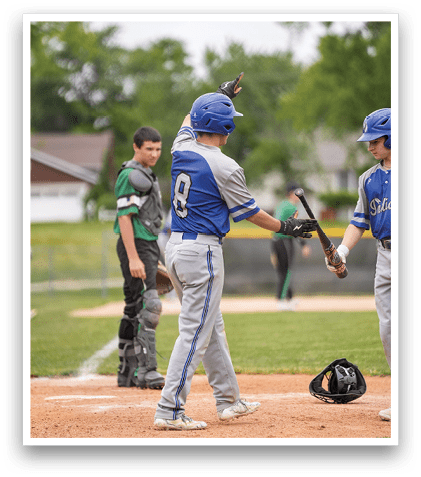 A baseball player is holding a bat and getting ready to swing. Description generated by AI