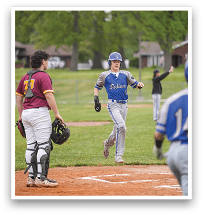 A baseball player wearing a blue and white uniform is running to first base. Description generated by AI