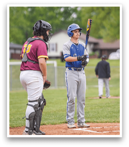 A baseball player holding a bat. Description generated by AI