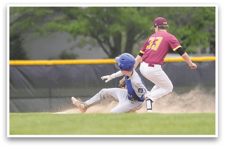 A baseball player slides into home plate. Description generated by AI