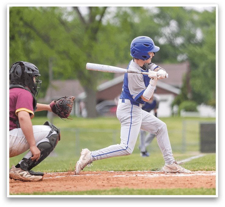 A baseball player is swinging a bat at a ball. Description generated by AI