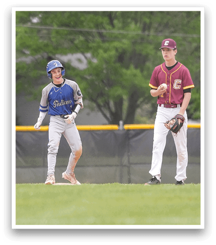 A boy in a blue and grey shirt is running on a baseball field. Description generated by AI