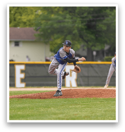 A baseball player in a blue and white uniform is standing on a field. Description generated by AI