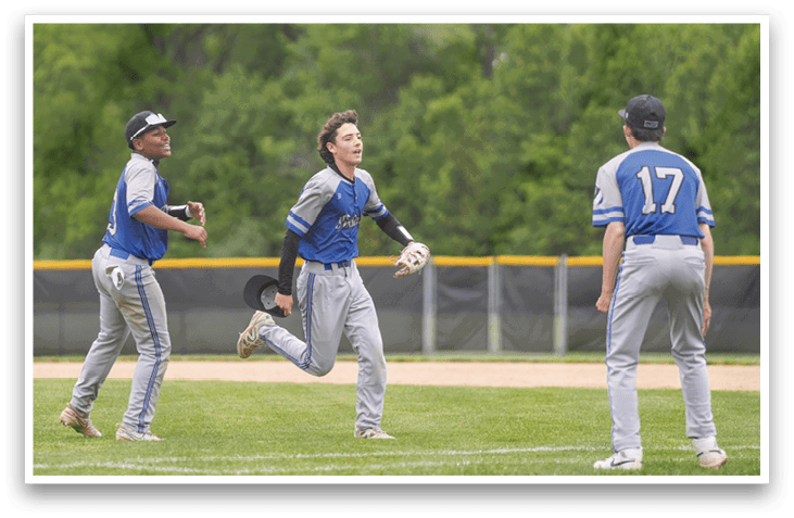 A group of young men playing baseball. Description generated by AI