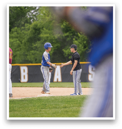 A baseball player in a blue helmet shakes hands with another player. Description generated by AI
