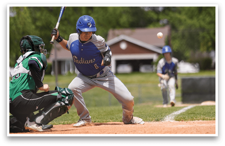 A baseball player is swinging a bat at a ball. Description generated by AI